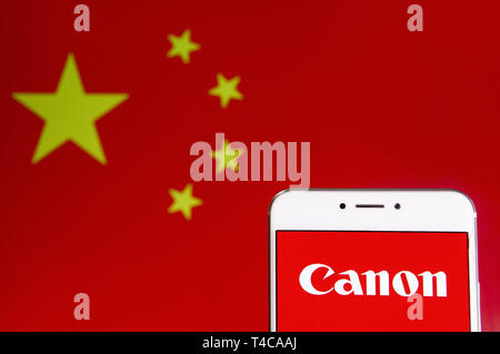 Hong Kong. 6th Apr, 2019. In this photo illustration a Japanese multinational electronics corporation Canon logo is seen on an Android mobile device with People's Republic of China flag in the background. Credit: Budrul Chukrut/SOPA Images/ZUMA Wire/Alamy Live News Stock Photo