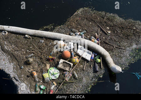 Plastic waste polluting into nature. rubbish and bottles floating on water Stock Photo