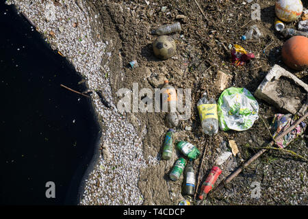 Plastic waste polluting into nature. rubbish and bottles floating on water Stock Photo