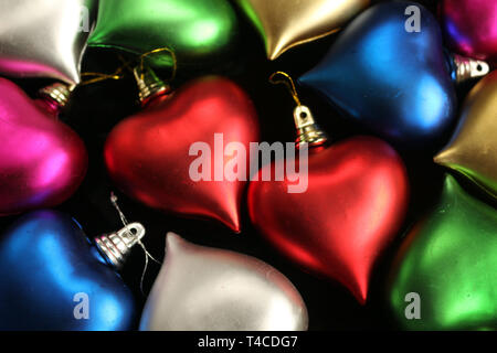Two Red Hearts Surrounded by Other Colourful Heart Decorations Stock Photo