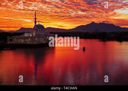Scenic view of floating mosque on Sarawak river with colorful sunset clouds background. Waterfront landmark in Kota Kuching. Traditional culture Stock Photo