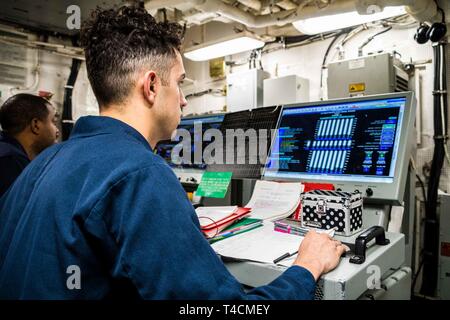 OCEAN (March 19, 2019) Engineman 2nd Class Josiah McNeill, from Lumberton, N.C., stands watch as Propulsion and Auxiliary Control Console Monitor in the main machinery room on board dock landing ship USS Harpers Ferry (LSD 49). Harpers Ferry is underway conducting routine operations as a part of USS Boxer Amphibious Ready Group (ARG) in the eastern Pacific Ocean. Stock Photo