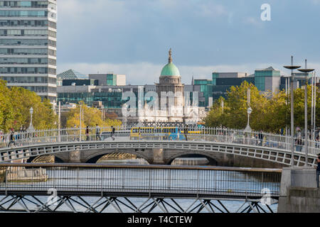 Dublin, OCT 28: Morning view of the famous Ha'penny Bridge with The Custom House behind on OCT 28, 2018 at Dublin, Ireland Stock Photo