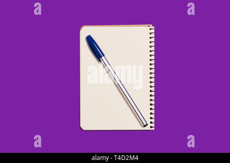 opened spiral notebook with a pen Stock Photo