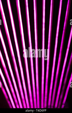 Abstact blurred neon lines on black background. Trendy 80s concept. Stock Photo