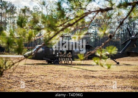 (FORT BENNING, Ga) -  Soldiers conduct pathfinder training at the Liberty Pickup Zone on post March 21, 2019.   During this portion of the training Soldiers conduct a VIRS Transmission and airborne operations from UH-60 Black Hawk helicopters.  The U.S. Army pathfinder School teaches Soldiers to infiltrate areas and set up parachute drop zones for airborne and air assault operations. Stock Photo