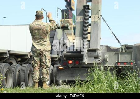 A Soldier from the 96th Transportation Company ground guides a Heavy ...