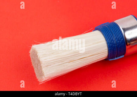 white round paintbrush on red background Stock Photo