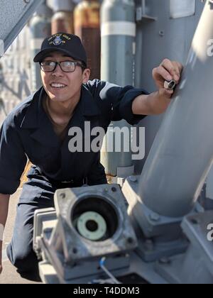 ATLANTIC OCEAN (March 20, 2019) Cryptologic Technician (Technical) Seaman Apprentice Angel Anthony Morales, from Ventura, California, and a Sailor assigned to the intelligence department of the Nimitz-class aircraft carrier USS George Washington (CVN 73), performs maintenance on a weapons system aboard the Ticonderoga-class guided missile cruiser USS Leyte Gulf (CG 55). Stock Photo
