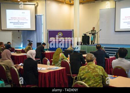 KUCHING, Malaysia (April 1, 2019) – Malaysian Army Col. Mohd Sakri Hussin, Malaysian Armed Forces senior principal assistant director, addresses the audience about roles and responsibilities during a Humanitarian Assistance and Disaster Relief conference at Sarawak State Library as part of Pacific Partnership 2019. The conference enabled civilian and military officials to discuss policies and procedures for responding to natural disasters and emergencies. Pacific Partnership, now in its 14th iteration, is the largest annual multinational humanitarian assistance and disaster relief preparedness Stock Photo