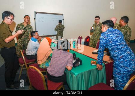 KUCHING, Malaysia (April 3, 2019) – Malaysian officials and Pacific Partnership 2019 personnel discuss disaster crisis management contingencies during a Humanitarian Assistance and Disaster Relief tabletop exercise at Sarawak State Library as part of Pacific Partnership 2019. The exercise allowed civilian and military officials to discuss policies and procedures for responding to various stages of natural disasters and emergencies. Pacific Partnership, now in its 14th iteration, is the largest annual multinational humanitarian assistance and disaster relief preparedness mission conducted in th Stock Photo