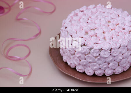 Festive cake covered with pink cream on a pink background Stock Photo