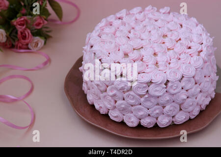 Festive cake covered with pink cream on a pink background Stock Photo