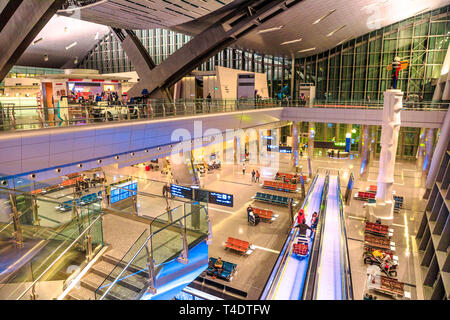 Doha, Qatar - February 24, 2019: aerial view of interior lobby and escalator of Hamad International Airport or Doha Hamad Airport, the only airport in Stock Photo