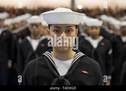 GREAT LAKES Ill. March 22 2019 Graduating Sailors stand in formation after entering Midway Ceremonial Drill Hall during a pass in review graduation ceremony at Recruit Training Command. More than 35 0...