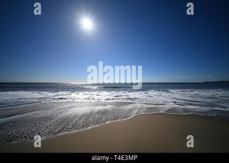 Malibu beach with the sun in the sky Stock Photo