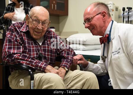 Air Force retired Lt. Col. Richard Cole sees Dr. Robert Kruger, 59th Medical Wing geriatric internal medicine doctor, at Wilford Hall Ambulatory Surgical Center, Joint Base San Antonio-Lackland, Texas, March 29, 2019. Lt. Col. Cole is the last surviving co-pilot from the Doolittle Raid on April 18, 1942. Stock Photo