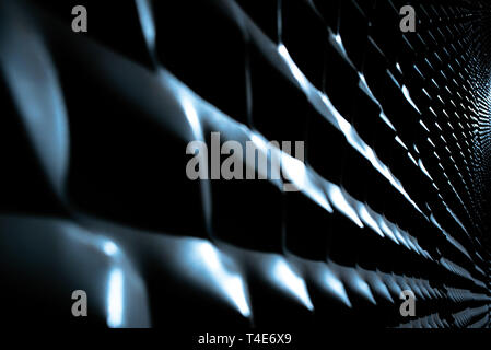 Industrial background with metallic texture illuminated with strong light and intense shadows and repetitive pattern. Stock Photo