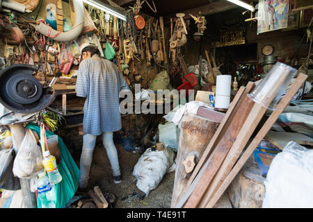 BANGKOK, THAILAND - MARCH 2019: Carpenter working in his teak wook workshop in Golden Mount region. Stock Photo