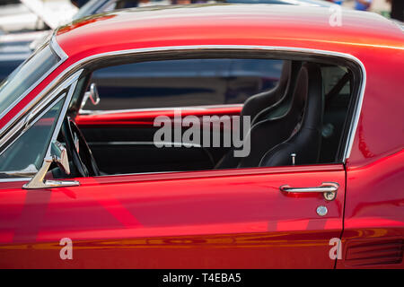 Driver side view of a fully restored classic mustang with race seats chrome accents. Stock Photo