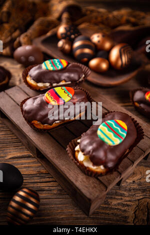 Fresh profitler eclairs with Easter decoration Stock Photo
