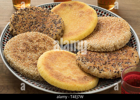 Traditional dish with Moroccan harcha with semolina, multigrain and sesame seed, flatbread close up Stock Photo