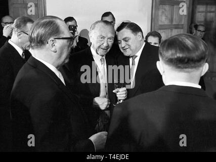 German chancellor Konrad Adenauer (M) talks to Franz Josef Strauss (r) at a reception on the 5th of January in 1963. | usage worldwide Stock Photo