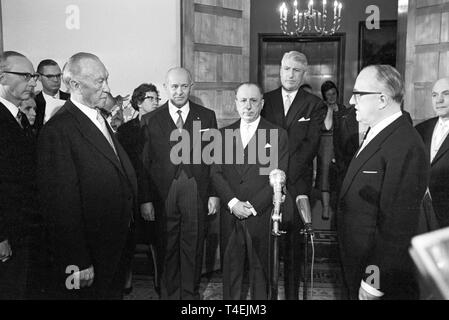 German chancellor Konrad Adenauer (l)  talks to representatives of the European Economic Community (not identified) at a reception on the 5th of January in 1963. | usage worldwide Stock Photo