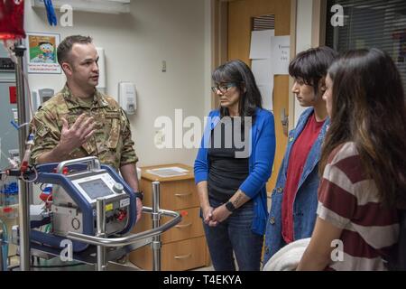 Air Force Maj. (Dr.) Matthew Read, acting Extracorporeal Membrane Oxygenation medical director, demonstrates the ECMO machine for Rita Ibanez and her children at Brooke Army Medical Center, Fort Sam Houston, Texas, March 22, 2019. The adult ECMO mission began at BAMC in 2012. Today, a designated team of Army, Air Force and Navy physicians, nurses, technicians and program managers is able to provide round-the-clock care to four patients simultaneously. Stock Photo