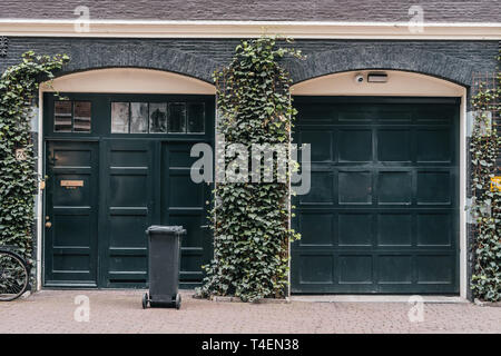 Traditional european garage with black brick and dark gates Stock Photo