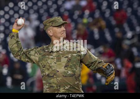 Maj. Gen. James Jacobson, Air Force District of Washington and the 320th Air Expeditionary Wing commander, throws the first pitch to the Washington Nationals vs Philadelphia Phillies game at Nationals Park, Washington, April 2, 2019. The Nationals hosted a Military Appreciation Day with the game, giving special recognition to Jacobson for his leadership in AFDW and the 320th AEW. Stock Photo