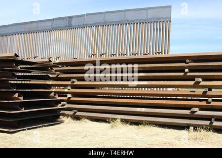 Fabricated fence panels await installation by USACE contractors, to add to existing 30-foot-tall San Diego secondary border wall (back) on March 29, 2019. The Corps is supporting the Department of Homeland Security's request to build additional border wall near San Diego. Stock Photo