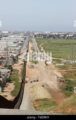 A view of the existing San Diego primary border wall (left) from 'Tin Can Hill,' and the cleared terrain for the San Diego secondary border wall (right) on March 29, 2019.  The Corps is supporting the Department of Homeland Security's request to build additional border wall near San Diego. Stock Photo
