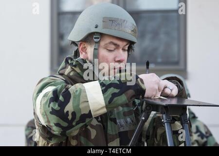 U.S. Air Force Tech. Sgt. John Matlock, 673d Medical Group noncommissioned officer in charge of radiation, writes the date and time on M8 chemical agent detector paper during exercise Polar Force at Joint Base Elmendorf-Richardson, Alaska, April 2, 2019. Polar Force is a two-week exercise designed to test JBER’s mission readiness, and develops the skills service members require to face adverse situations. Stock Photo