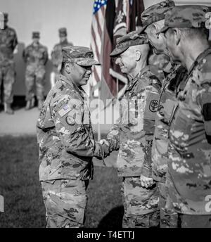 U.S. Army Brig. Gen Ron Stephens, RHCE's Commanding General, awards the EFMB to Capt. Ricardo Carino, assigned to the 212th Combat Support Hospital (CSH) on April 2nd, 2019. Stock Photo