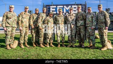 The command teams for 30th Medical Brigade, 212th Combat Support Hospital (CSH) and 421st Multifunctional Medical Battalion stand with all four of their newest EFMB graduates, on April 2nd, 2019. Stock Photo