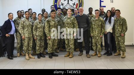 Naval Supply Systems Command (NAVSUP) Commander RADM Michelle Skubic (middle) visits with the NAVSUP Fleet Logistics Center’s Aviation Supply Division (ASD) team March 26, 2019 at Naval Air Station (NAS) Sigonella, Sicily, Italy. ASD's mission is to provide supply and logistics support to all forward deployed patrol squadrons across the U.S. Naval Forces Europe/Africa Command and the Aircraft Intermediate Maintenance Detachment, the only such detachment in the Mediterranean. Also, ASD serves the supply function for the Commander Fleet Air Sigonella organization headed by Command Task Force-67  Stock Photo