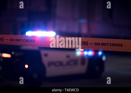 911 response crime scene investigation. Police crime tape blacking off the street during a crime investigation. Stock Photo