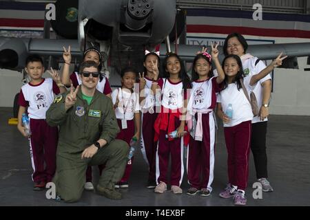 students from sapang bato elementary school and us air force capt basher piepenbring an a 10 thunderbolt lightning ii pilot with the 25th fighter squadron pose for a photo in front of an a 10 at clark air base philippines april 6 2019 during exercise balikatan balikatan is an annual exercise between the us and the philippines and comes from a tagalog phrase meaning shoulder to shoulder representing the partnership between the two countries the exercise promotes regional security and humanitarian efforts for us allies and partners
