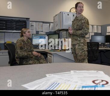 U.S. Air Force Airman 1st Class Maria Taunton, left, and A1C Megan Cardoza, both with the 60th Aerial Port Squadron Transportation Management Office, listen to a customer, April 8, 2019, at Travis Air Force Base, California. The TMO is responsible for ensuring the efficient transport of a service members’ household goods. Stock Photo