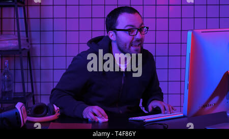 Gamer playing a game very excited and commenting on the game. Stock Photo