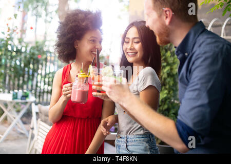 Group of friends having fun together. People talking laughing and enjoying their time Stock Photo