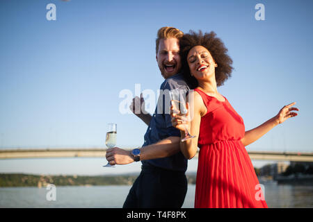 Romantic happy couples dancing and drinking at party Stock Photo