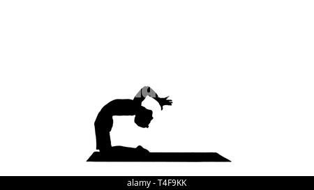 Silhouette Yogi doing camel yoga pose. Stock Photo