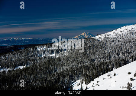 Mt Rainier seen from Mission ridge about 69 miles northeast during winter appears very large because of the relatively low lands surrounding the peak. Stock Photo