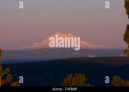 Mt Rainier seen from Mission ridge about 69 miles northeast during winter appears very large because of the relatively low lands surrounding the peak. Stock Photo