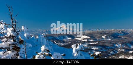 Mt Rainier seen from Mission ridge about 69 miles northeast during winter appears very large because of the relatively low lands surrounding the peak. Stock Photo