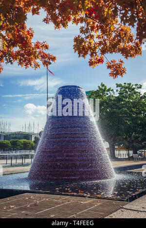 Fountain on the waterways on Alameda dos Oceanos promenade in Park of Nations, Lisbon, Portugal. Lisbon Oceanarium on background Stock Photo