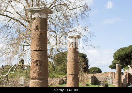 Landscape at archaeological excavations in Ostia Antica : the perspective view of the Roman columns - selected focus on first column Stock Photo