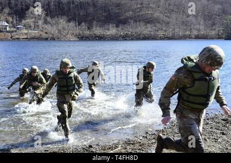 U.S. Army Reserve Officers’ Training Corps Cadets from Lehigh University, Bethlehem, Pennsylvania run onto shore after testing the water depth of Stillwell Lake, West Point, New York during training in preparation for the U.S. Military Academy’s 51st Sandhurst Military Skills Competition, April 12-13. Sandhurst, a premier international military academy competition which began in 1967, is a two-day, approximately 30-mile course filled with individual and squad-based events designed to promote military excellence of future leaders across the world. This year, 49 teams from more than a dozen coun Stock Photo